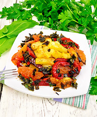 Image showing Courgettes with vegetables in plate on light board