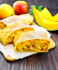 Image showing Strudel pumpkin and apple with raisins on wooden board