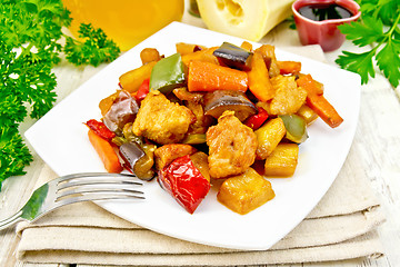 Image showing Roast with vegetables and honey in plate on towel