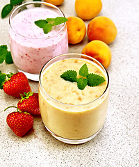 Image showing Milkshake apricot and strawberry on granite table