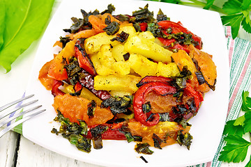 Image showing Courgettes with vegetables in plate on board