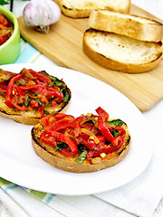 Image showing Bruschetta with vegetables in plate on board