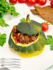 Image showing Squash green stuffed with meat and vegetables on light board