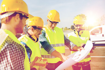 Image showing group of builders with tablet pc and blueprint