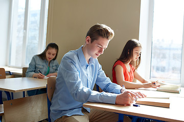 Image showing group of students with books writing school test