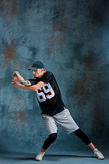 Image showing Young man break dancing on wall background.