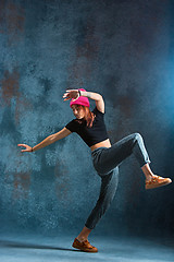 Image showing Young girl break dancing on wall background.