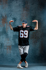 Image showing Young man break dancing on wall background.