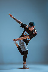 Image showing Young man break dancing on wall background.