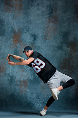 Image showing Young man break dancing on wall background.