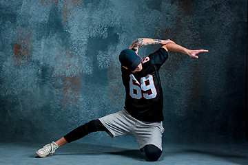 Image showing Young man break dancing on wall background.