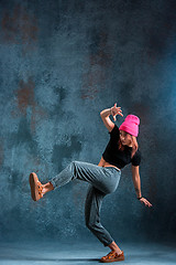 Image showing Young girl break dancing on wall background.