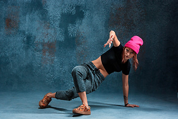 Image showing Young girl break dancing on wall background.