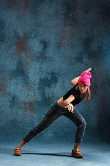 Image showing Young girl break dancing on wall background.