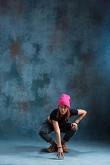 Image showing Young girl break dancing on wall background.