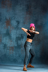 Image showing Young girl break dancing on wall background.