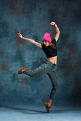 Image showing Young girl break dancing on wall background.