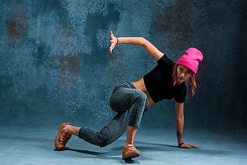 Image showing Young girl break dancing on wall background.