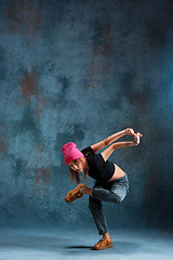 Image showing Young girl break dancing on wall background.