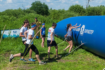 Image showing Athletes overcome inflatable obstacle. Tyumen