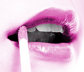 Image showing Girl Applying Mauve Lip Gloss To Her Lips