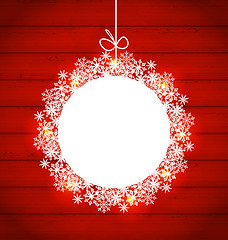 Image showing Christmas round frame made in snowflakes on red wooden backgroun