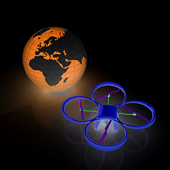 Image showing Quadrocopter Drone with Earth Globe and remote controller on a w