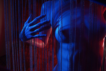 Image showing female breast behind curtain