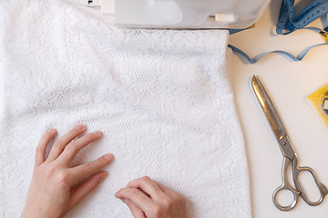 Image showing Girl prepares fabric for sewing