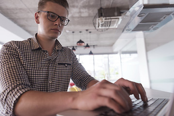 Image showing young  man working on laptop