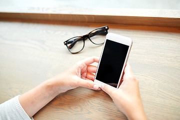 Image showing close up of woman texting on smartphone