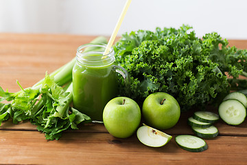 Image showing close up of jug with green juice and vegetables