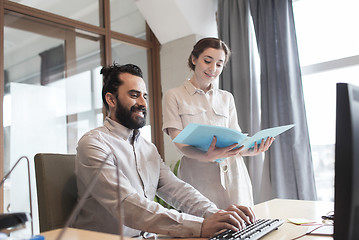 Image showing happy creative team with computer in office