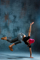 Image showing Young girl break dancing on wall background.