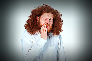 Image showing Young man is having toothache.