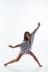 Image showing Young beautiful dancer in beige dress dancing on white background