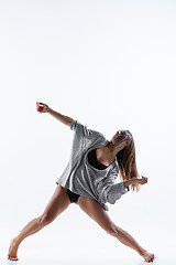 Image showing Young beautiful dancer in beige dress dancing on white background