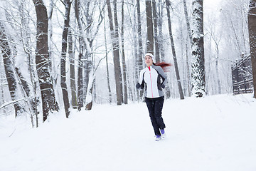 Image showing Young sportswoman running in morning