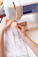 Image showing Photos of sewing-machine, seamstress hands