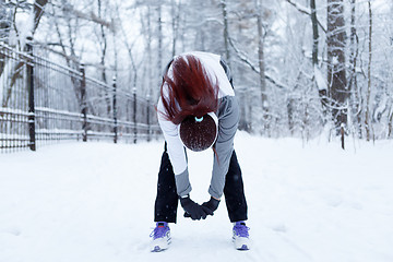 Image showing Winter woman in stretching exercises