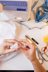 Image showing Seamstress in atelier unrips fabric