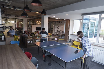 Image showing playing ping pong tennis at creative office space