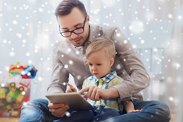 Image showing father and son with tablet pc playing at home