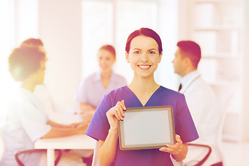 Image showing happy doctor over group of medics at hospital