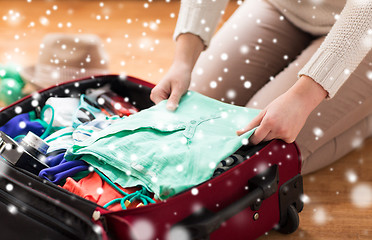 Image showing close up of woman packing travel bag for vacation