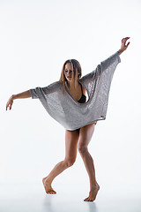 Image showing Young beautiful dancer in beige dress dancing on white background