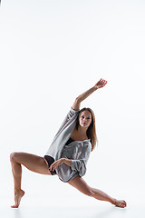 Image showing Young beautiful dancer in beige dress dancing on white background