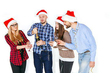 Image showing Many young women and men drinking at christmas party