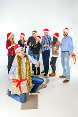 Image showing Many young women and men drinking at christmas party