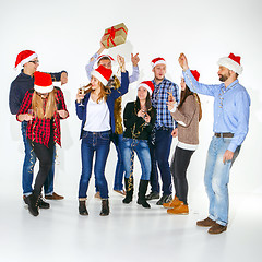 Image showing Many young women and men drinking at christmas party